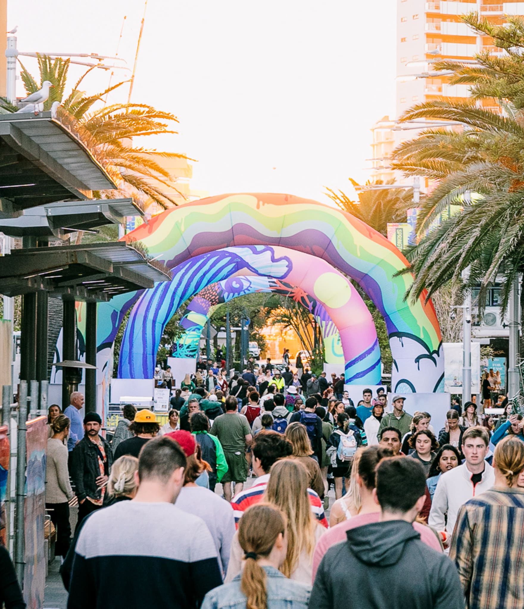 Photo of crowd walking around Springtime Festival with large overhad art installations at SpringTime Festival Gold Coast 2-4 September 2022